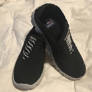 Black slip on tennis shoes.